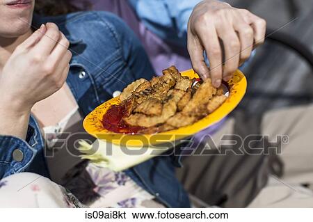 Cropped close up of couple eating chips View Large Photo Image Stock Photograph - Cropped close up of couple eating chips. Fotosearch