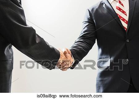 Stock Photography - Cropped shot of male business lawyers shaking hands in office. Fotosearch
