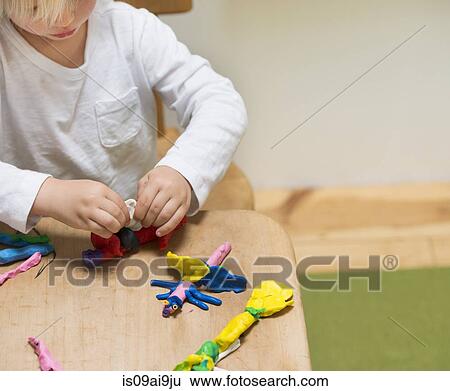Cropped shot of three year old boy playing with modeling clay View Large Photo Image Stock Photograph - Cropped shot of three year old boy playing with modeling clay. Fotosearch
