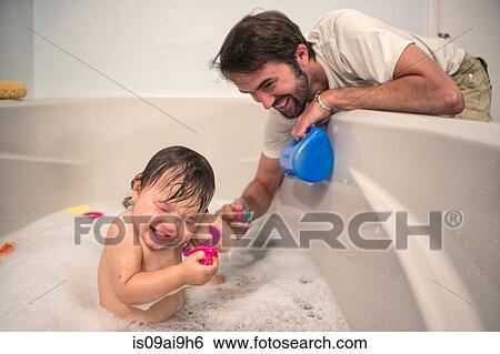 Father and toddler daughter playing at bath time View Large Photo Image Stock Photograph - Father and toddler daughter playing at bath time. Fotosearch