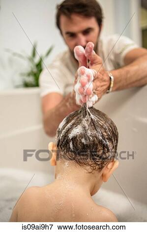 Stock Photo - Father shampooing toddler daughters hair at bath time. Fotosearch