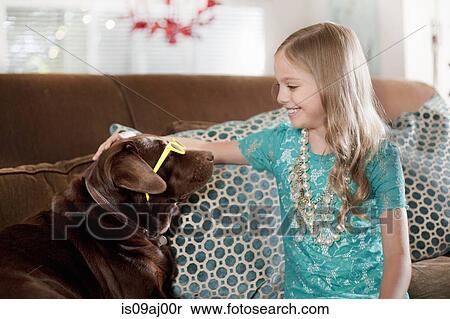 Stock Photography - Girl with chocolate colored labrador dog wearing sunglasses. Fotosearch