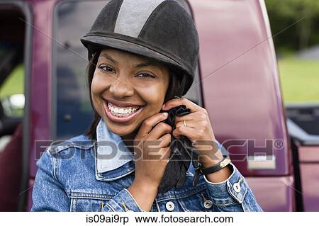 Horse rider putting on riding hat View Large Photo Image Stock Photography - Horse rider putting on riding hat. Fotosearch