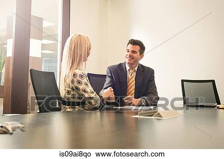 Picture - Male and female business lawyers shaking hands in office. Fotosearch