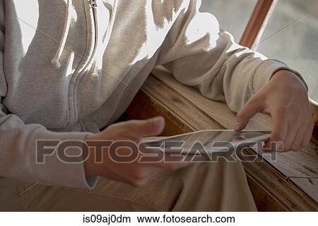 Picture - Man using digital tablet. Fotosearch