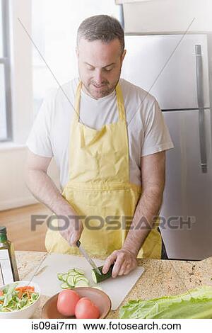 Mature man preparing fresh salad in kitchen View Large Photo Image Picture - Mature man preparing fresh salad in kitchen. Fotosearch