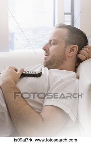 Mature man with remote control asleep on sofa View Large Photo Image Stock Image - Mature man with remote control asleep on sofa. Fotosearch