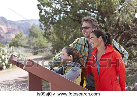Mature parents and daughter reading sign whilst hiking, Sedona, Arizona, USA View Large Photo Image Stock Photo - Mature parents and daughter reading sign whilst hiking, Sedona, Arizona, USA. Fotosearch