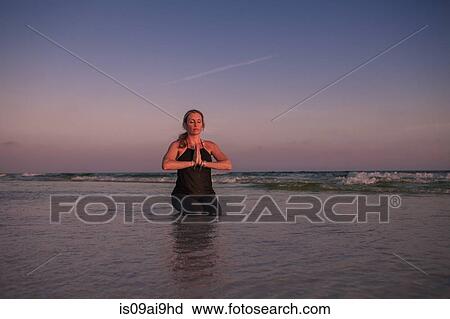 Mature woman practicing kneeling yoga pose on beach at sunset View Large Photo Image Stock Image - Mature woman practicing kneeling yoga pose on beach at sunset. Fotosearch
