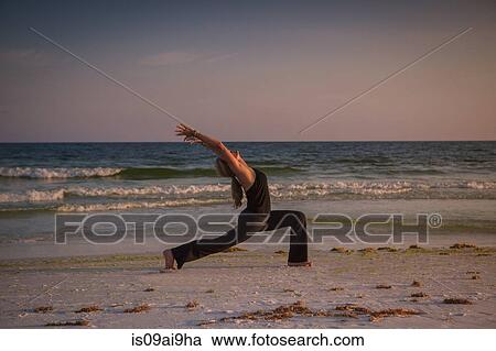 Mature woman practicing yoga on beach at sunset View Large Photo Image Stock Image - Mature woman practicing yoga on beach at sunset. Fotosearch