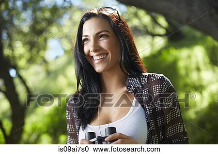 Mid adult woman birdwatcher in forest View Large Photo Image Stock Image - Mid adult woman birdwatcher in forest. Fotosearch