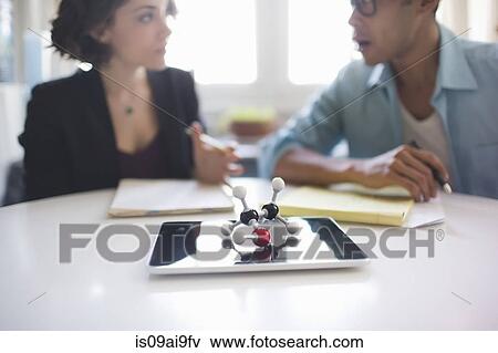 Stock Photo - Molecular model of Ethanol molecule, man and woman in discussion in background. Fotosearch