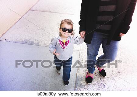 Stock Photo - Mother and daughter holding hands. Fotosearch