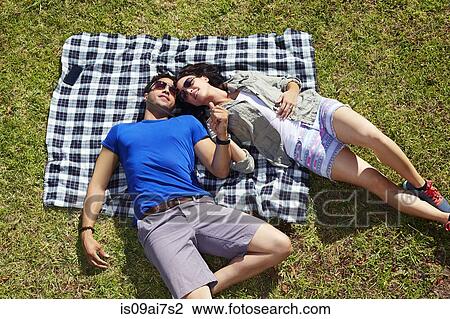 Overhead view of couple holding hands on picnic blanket View Large Photo Image Stock Image - Overhead view of couple holding hands on picnic blanket. Fotosearch