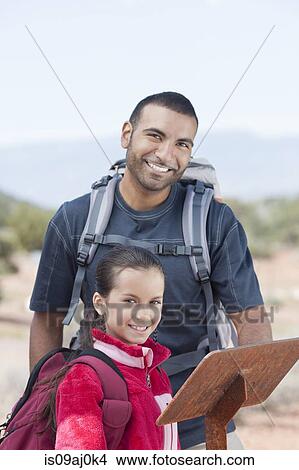 Portrait of father and daughter looking at sign whilst hiking, Sedona, Arizona, USA View Large Photo Image Picture - Portrait of father and daughter looking at sign whilst hiking, Sedona, Arizona, USA. Fotosearch