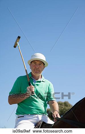 Portrait of mature man playing polo View Large Photo Image Stock Image - Portrait of mature man playing polo. Fotosearch