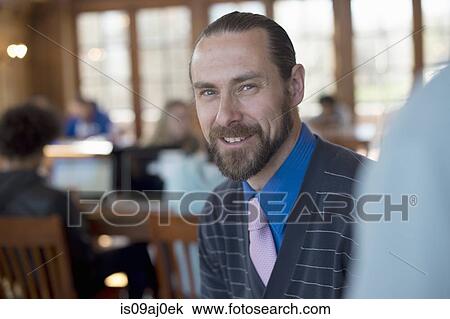 Stock Image - Portrait of mid adult man smiling. Fotosearch