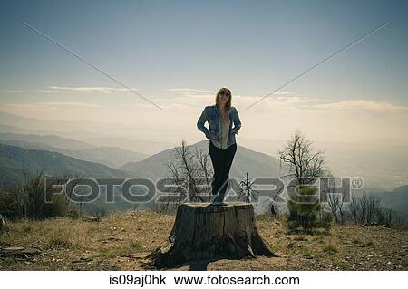 Portrait of mid adult woman standing on tree trunk, Lake Arrowhead, California, USA View Large Photo Image Stock Image - Portrait of mid adult woman standing on tree trunk, Lake Arrowhead, California, USA. Fotosearch
