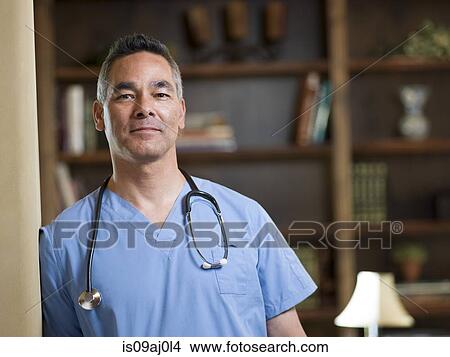 Portrait of smiling mature doctor in office View Large Photo Image Picture - Portrait of smiling mature doctor in office. Fotosearch