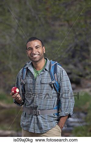 Portrait of young male hiker eating apple, Sedona, Arizona, USA View Large Photo Image Stock Image - Portrait of young male hiker eating apple, Sedona, Arizona, USA. Fotosearch