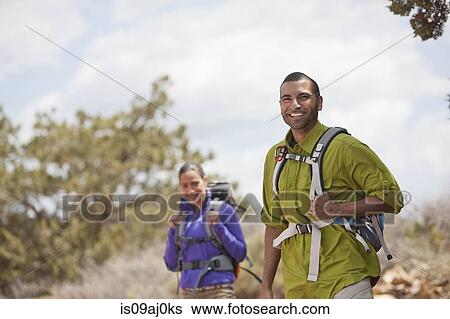Portrait of young man and his girlfriend hiking, Sedona, Arizona, USA View Large Photo Image Stock Photograph - Portrait of young man and his girlfriend hiking, Sedona, Arizona, USA. Fotosearch