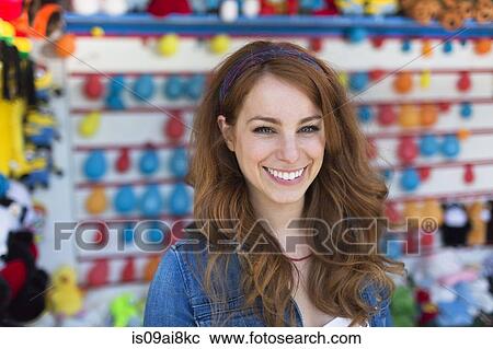 Portrait of young woman at fairground stall View Large Photo Image Stock Image - Portrait of young woman at fairground stall. Fotosearch