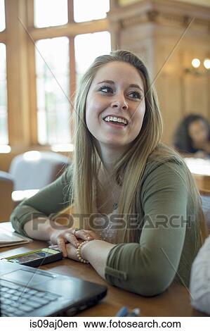 Portrait of young woman with laptop, smiling View Large Photo Image Picture - Portrait of young woman with laptop, smiling. Fotosearch