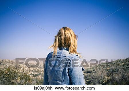Rear view of mid adult woman gazing at view, Lake Arrowhead, California, USA View Large Photo Image Stock Image - Rear view of mid adult woman gazing at view, Lake Arrowhead, California, USA. Fotosearch