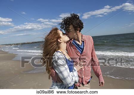 Stock Photograph - Romantic couple kissing on beach. Fotosearch