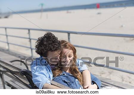 Romantic couple on park bench at beach View Large Photo Image Stock Photograph - Romantic couple on park bench at beach. Fotosearch