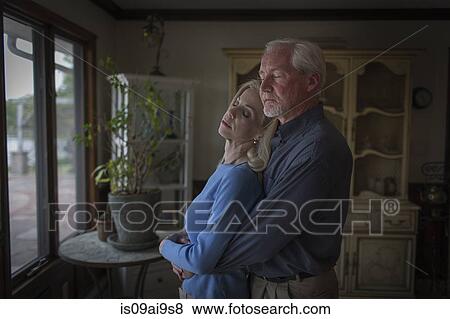 Romantic mature couple hugging with eyes closed in dining room View Large Photo Image Stock Photo - Romantic mature couple hugging with eyes closed in dining room. Fotosearch