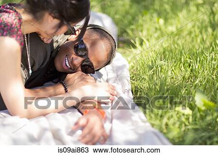 Romantic young couple on picnic blanket in park View Large Photo Image Stock Image - Romantic young couple on picnic blanket in park. Fotosearch