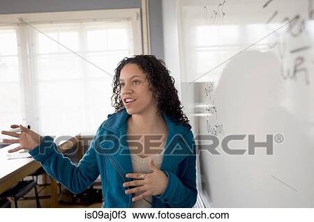 Stock Image - Student by whiteboard. Fotosearch