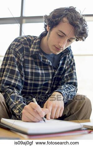 Stock Image - Student making notes. Fotosearch