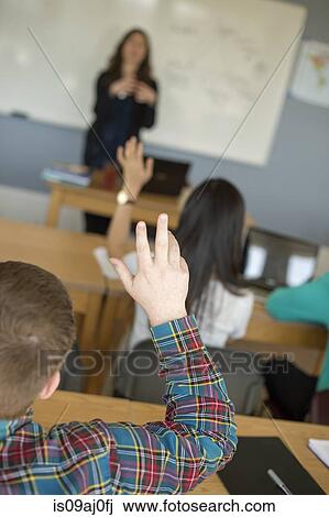 Student with raised hands in classroom View Large Photo Image Stock Image - Student with raised hands in classroom. Fotosearch