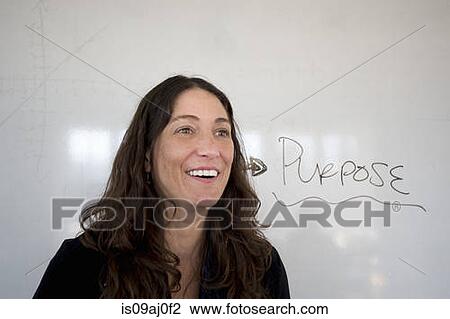 Teacher by whiteboard with word 'purpose' written on it View Large Photo Image Stock Image - Teacher by whiteboard with word 'purpose' written on it. Fotosearch