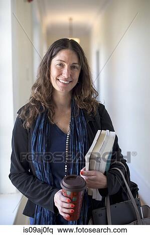 Teacher holding books and coffee, portrait View Large Photo Image Stock Photography - Teacher holding books and coffee, portrait. Fotosearch