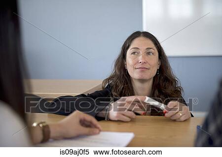 Stock Photography - Teacher listening in classrooom. Fotosearch