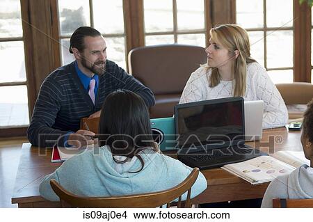 Picture - Teacher talking to college students. Fotosearch