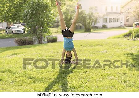 Teenage girl doing headstand View Large Photo Image Picture - Teenage girl doing headstand. Fotosearch
