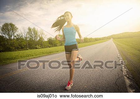 Teenage girl running on road View Large Photo Image Picture - Teenage girl running on road. Fotosearch