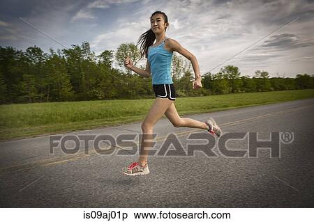 Teenage girl running on road View Large Photo Image Stock Photography - Teenage girl running on road. Fotosearch
