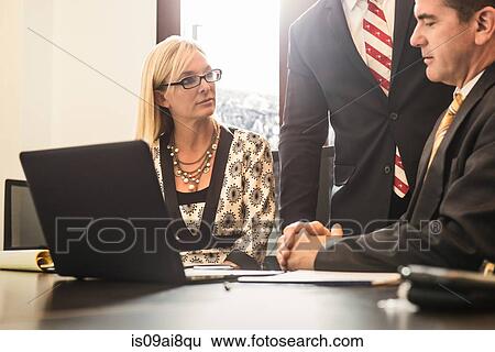 Stock Photograph - Three business lawyers meeting in office. Fotosearch