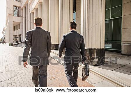 Stock Image - Two business lawyers with briefcase outside courthouse. Fotosearch