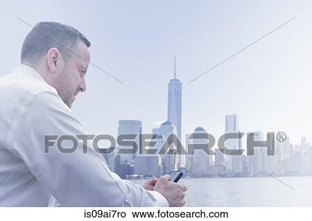 Picture - Unhappy mature man at Jersey City waterfront, New Jersey State, USA. Fotosearch
