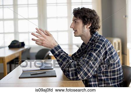 Stock Image - University student in classroom. Fotosearch