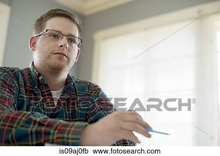 Stock Image - University student wearing glasses and checked shirt. Fotosearch