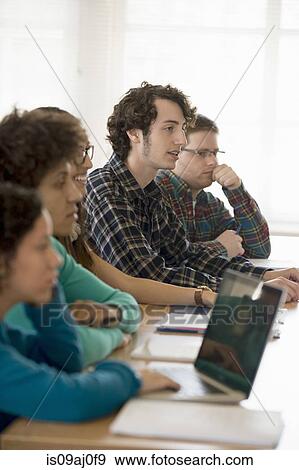 Stock Photo - University students in classrooom. Fotosearch