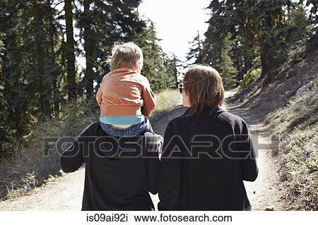 Women walking through forest in Oregon, USA, with toddler sitting on shoulders View Large Photo Image Stock Image - Women walking through forest in Oregon, USA, with toddler sitting on shoulders. Fotosearch