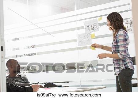 Young businesswoman presenting ideas to male colleagues View Large Photo Image Stock Image - Young businesswoman presenting ideas to male colleagues. Fotosearch